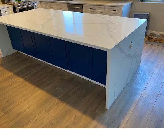 Calacatta quartz waterfall edge island by Mauricio's StoneCraft