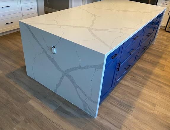 Calacatta quartz waterfall island installed by Mauricio's StoneCraft in Fort Worth
